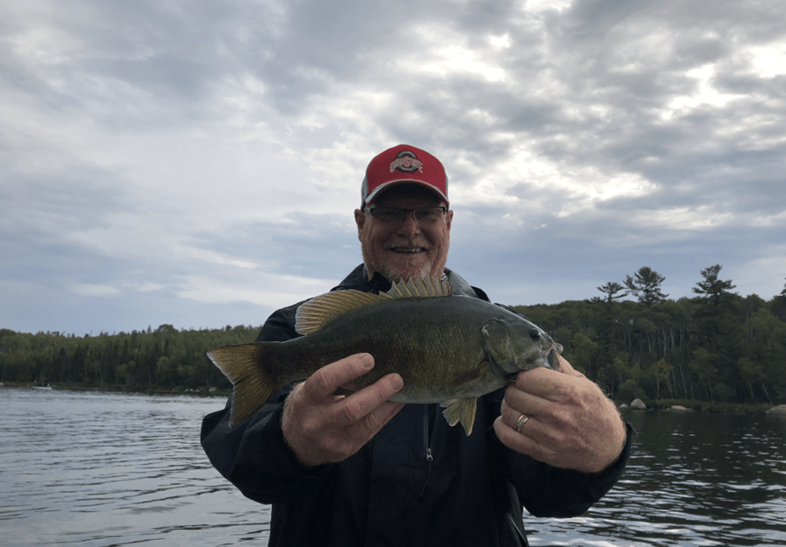 Man In Cap Showing Fish