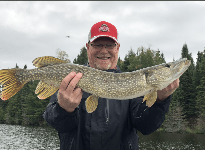 Happy Old Man Showing Fish